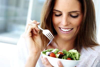 woman fighting disease by eating salad