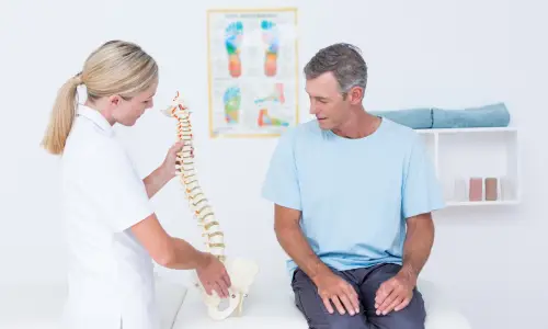 Blue Ridge Car Accident Chiropractor showing anatomical spine to her patient.