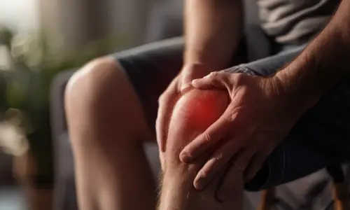 Man holding his knee because of knee pain